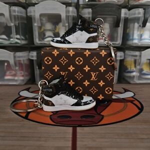 Fashion pair of mini sneakers keychain.